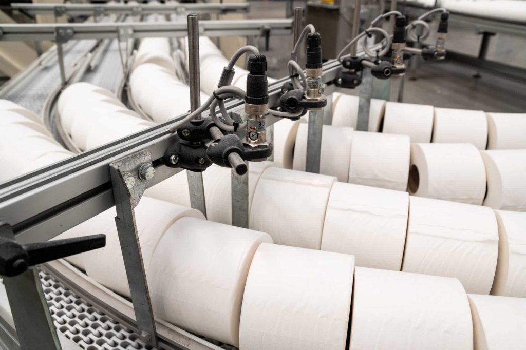 Toilet roll being manufactured on a production line